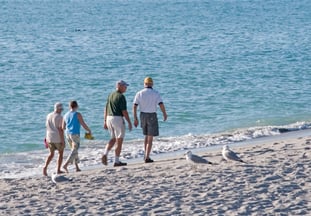 couples walking down the beach